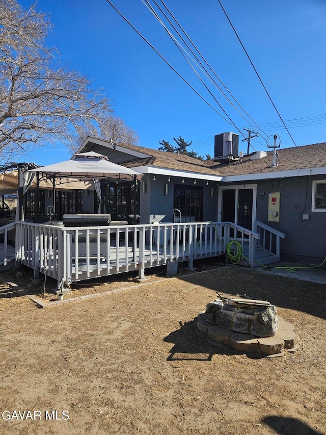 1283 W Lancaster Blvd, Lancaster, CA 93534 - rear view of house featuring a gazebo, a deck, and a fire pit