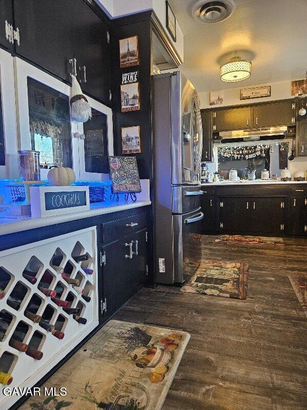 1283 W Lancaster Blvd, Lancaster, CA 93534 - bar area with freestanding refrigerator, under cabinet range hood, and wood finished floors