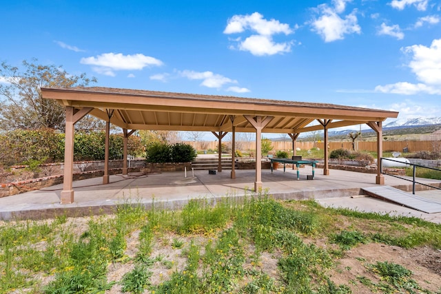 surrounding community with a patio area, fence, and a gazebo