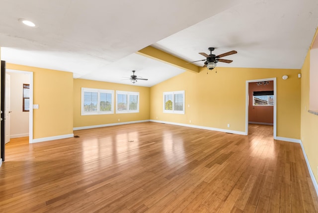 unfurnished living room with lofted ceiling with beams, ceiling fan, light wood-style flooring, and baseboards