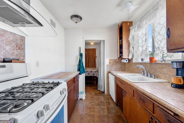 kitchen with tasteful backsplash, sink, white appliances, and wall chimney exhaust hood