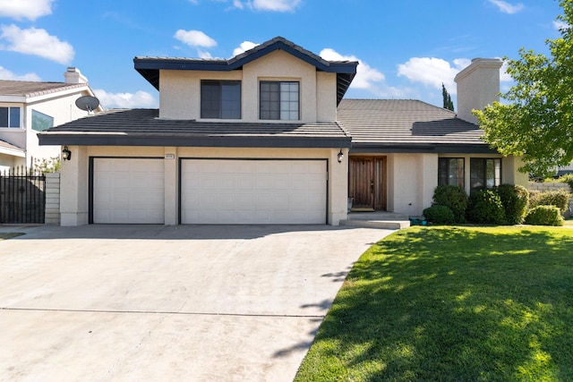 front facade featuring a garage and a front yard