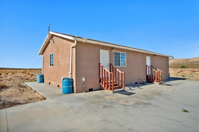 39441 E 140th St, Palmdale, CA 93591 - back of house with entry steps, a patio, crawl space, and stucco siding