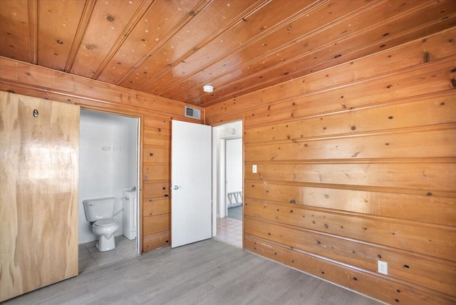 39441 E 140th St, Palmdale, CA 93591 - unfurnished bedroom featuring wooden walls, wood ceiling, connected bathroom, and wood finished floors