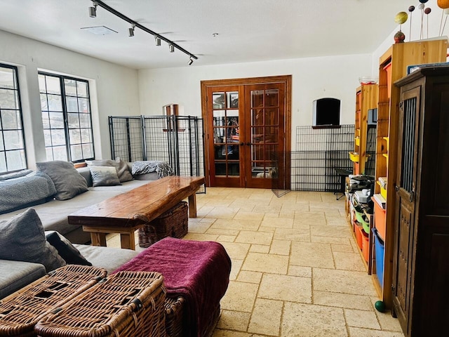 living room featuring french doors and track lighting