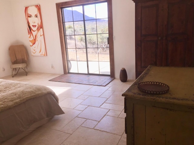 bedroom featuring access to exterior and a mountain view