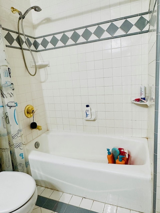 bathroom with tile patterned floors, toilet, and shower / bath combo with shower curtain