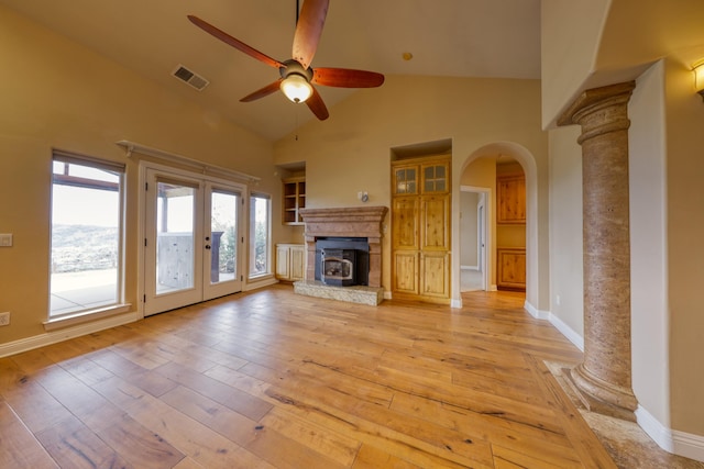 24281 Jacaranda Dr, Tehachapi, CA 93561 - unfurnished living room with visible vents, arched walkways, light wood finished floors, a ceiling fan, and high vaulted ceiling