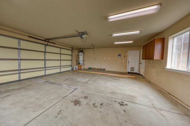 24281 Jacaranda Dr, Tehachapi, CA 93561 - garage with a garage door opener and secured water heater