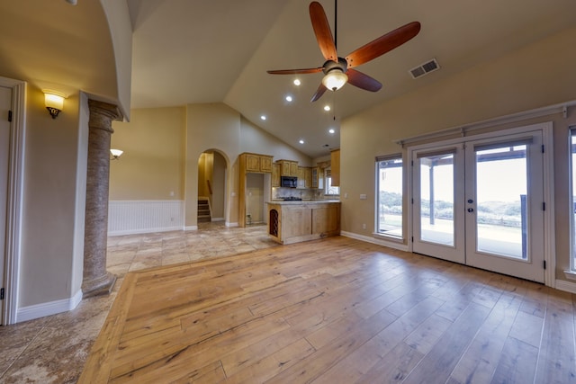 24281 Jacaranda Dr, Tehachapi, CA 93561 - unfurnished living room with arched walkways, a wainscoted wall, ceiling fan, visible vents, and french doors