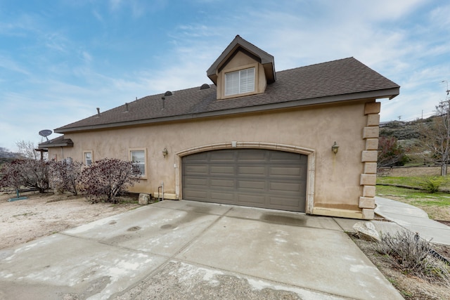 24281 Jacaranda Dr, Tehachapi, CA 93561 - view of property exterior with stucco siding, roof with shingles, concrete driveway, and an attached garage