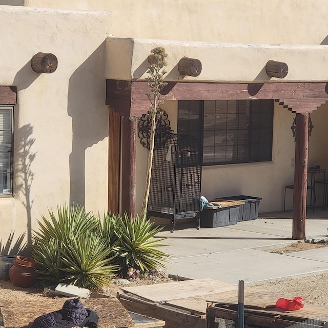 entrance to property featuring a patio