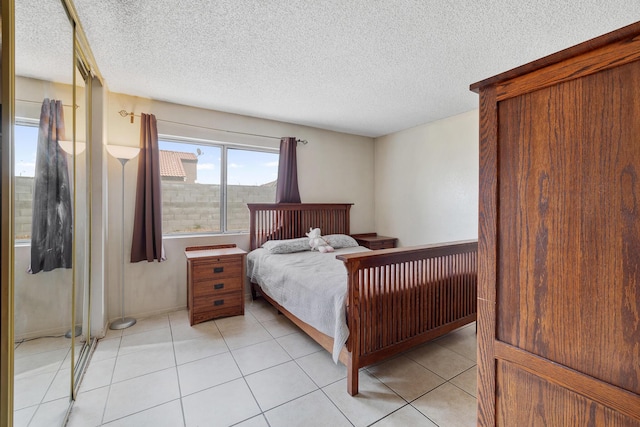 tiled bedroom featuring a textured ceiling