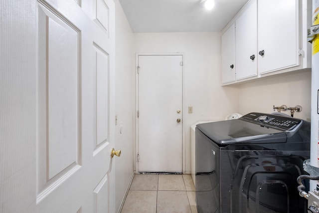 washroom featuring light tile patterned floors, washer / dryer, and cabinets