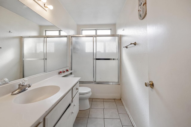 full bathroom featuring tile patterned floors, toilet, combined bath / shower with glass door, and vanity