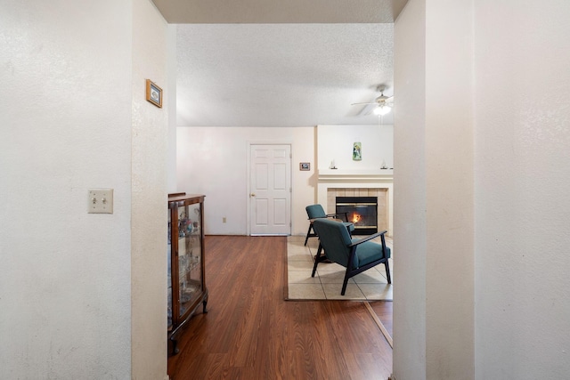 hallway featuring hardwood / wood-style floors and a textured ceiling