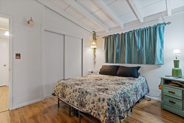 44008 E 3rd St, Lancaster, CA 93535 - bedroom featuring a closet, baseboards, wood finished floors, and lofted ceiling with beams