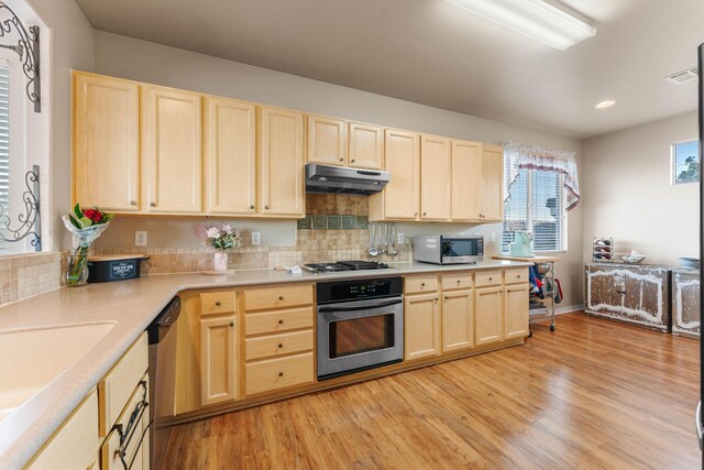 kitchen featuring light hardwood / wood-style floors, sink, light brown cabinets, and appliances with stainless steel finishes