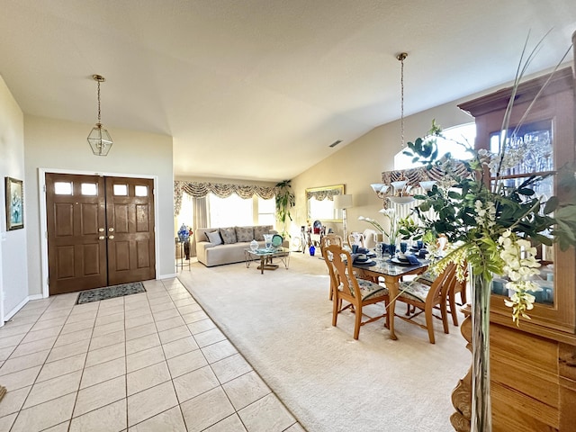 entryway featuring vaulted ceiling and light carpet