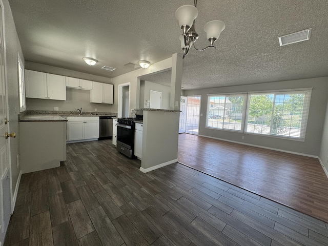 kitchen featuring white cabinets, decorative light fixtures, plenty of natural light, and appliances with stainless steel finishes