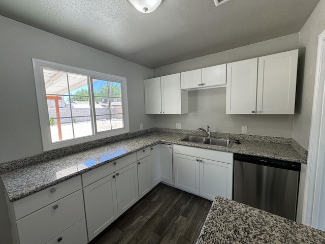 kitchen with dishwasher, white cabinetry, dark wood-type flooring, and sink