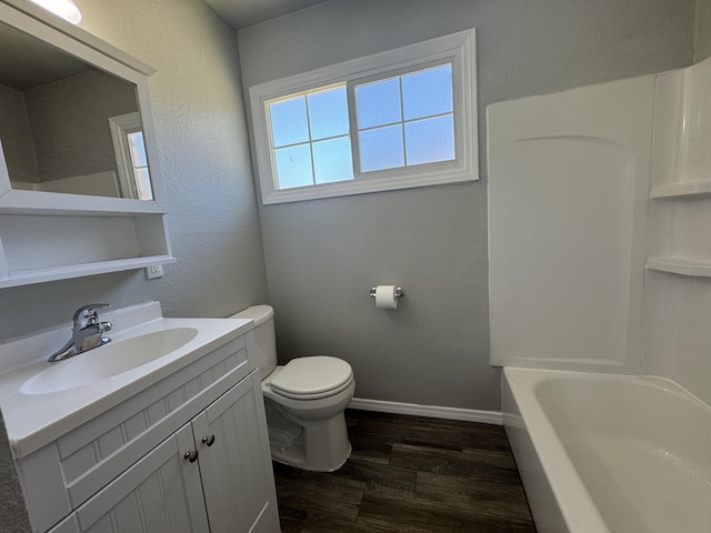 bathroom with wood-type flooring, vanity, and toilet