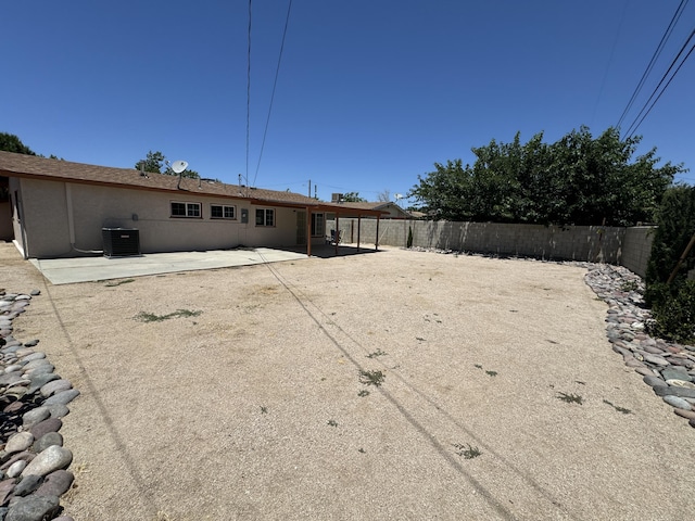 back of property featuring central AC unit and a patio area