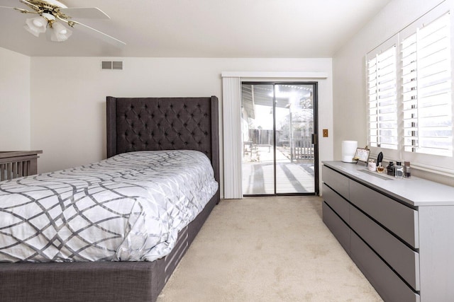 carpeted bedroom with ceiling fan, multiple windows, and access to outside