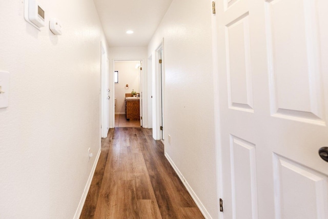 corridor featuring dark hardwood / wood-style flooring