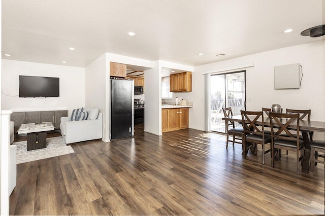 kitchen featuring appliances with stainless steel finishes and dark wood-type flooring