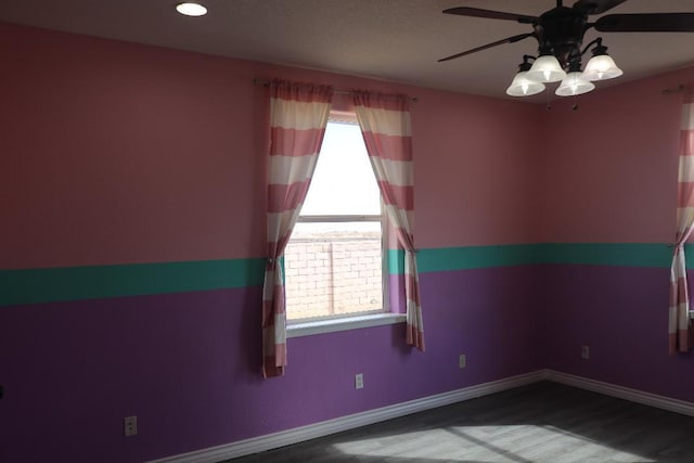 unfurnished room with baseboards, ceiling fan, and wood finished floors