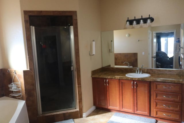 bathroom with vanity, a garden tub, a stall shower, and tile patterned floors