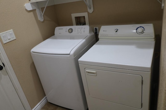 clothes washing area featuring independent washer and dryer