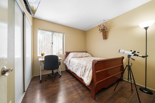 bedroom featuring a closet, baseboards, and wood finished floors