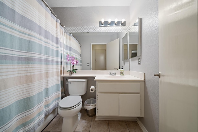 full bathroom featuring a textured wall, vanity, toilet, and tile patterned floors