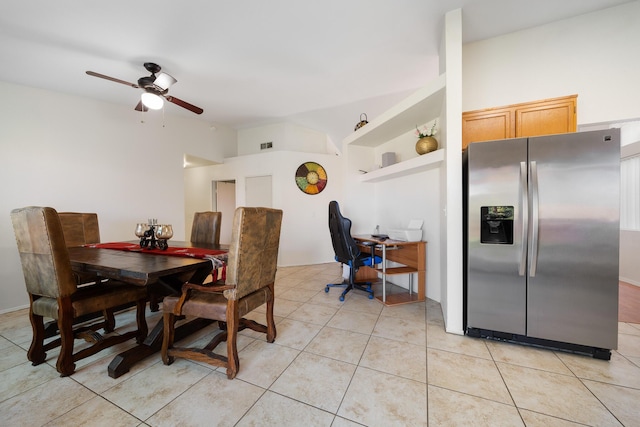 dining room with vaulted ceiling, light tile patterned flooring, visible vents, and a ceiling fan