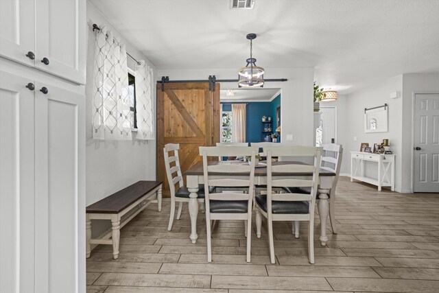 30140 Brassie Ct, Tehachapi, CA 93561 - dining space featuring a barn door and light wood finished floors