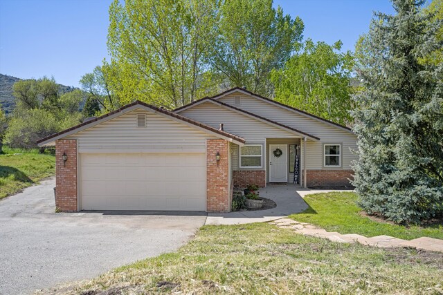 30140 Brassie Ct, Tehachapi, CA 93561 - view of front of property with brick siding, an attached garage, and asphalt driveway