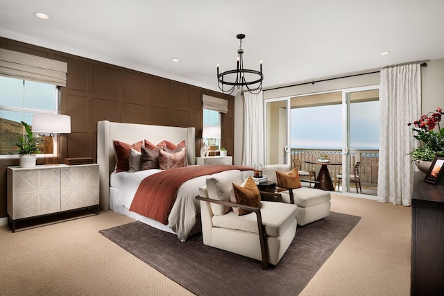 carpeted bedroom featuring access to exterior, a chandelier, multiple windows, and recessed lighting