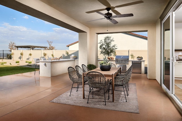 view of patio / terrace featuring outdoor dining space, a fenced backyard, grilling area, exterior kitchen, and ceiling fan