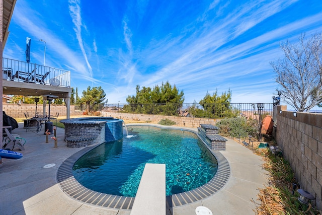 view of pool with a patio, pool water feature, an in ground hot tub, and a diving board