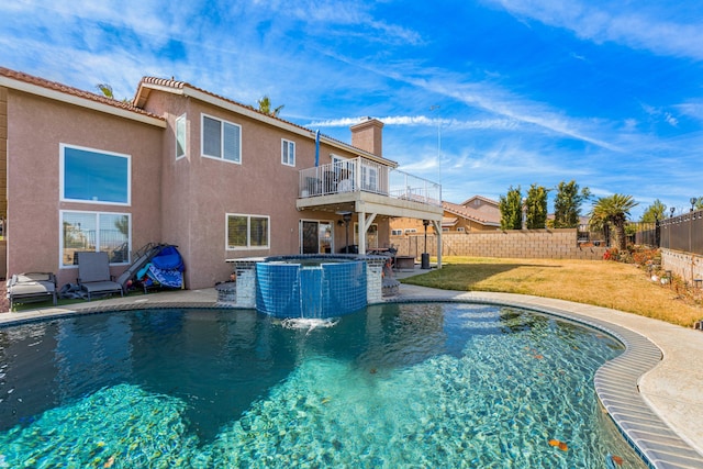 view of pool featuring a lawn, a patio area, and an in ground hot tub