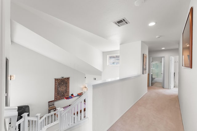 corridor with light colored carpet