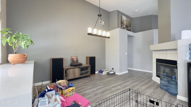36726 Sulphur Springs Rd, Palmdale, CA 93552 - living area with wood finished floors, a tiled fireplace, and a high ceiling
