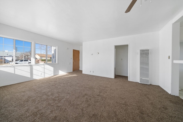 unfurnished living room with a ceiling fan, carpet floors, and visible vents