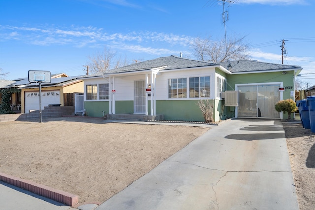view of front of home featuring a garage, concrete driveway, and stucco siding