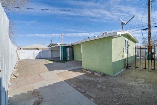 back of house featuring stucco siding, fence, and a patio area
