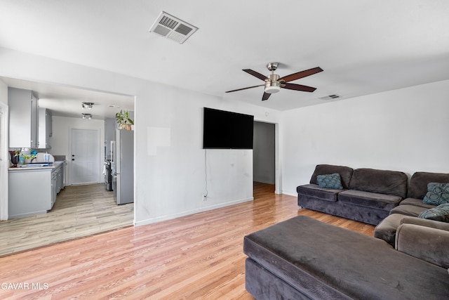 44049 Elm Ave, Lancaster, CA 93534 - living area with ceiling fan and light wood-style floors