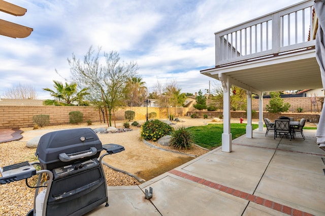 view of patio featuring a fenced backyard, grilling area, and outdoor dining space