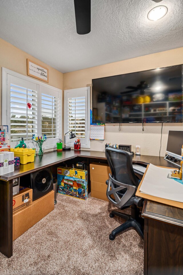 carpeted office featuring a textured ceiling